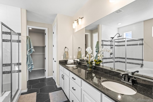 full bath featuring visible vents, a sink, a shower stall, and tile patterned floors