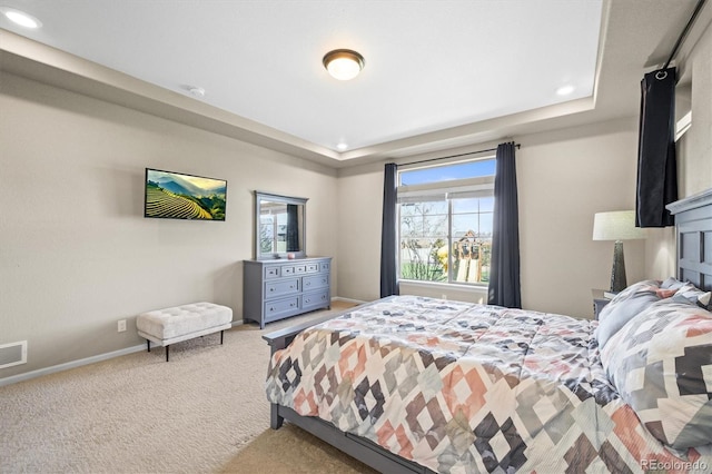 bedroom featuring recessed lighting, carpet, a raised ceiling, and baseboards