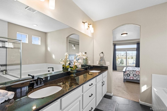full bathroom featuring visible vents, a healthy amount of sunlight, and a sink
