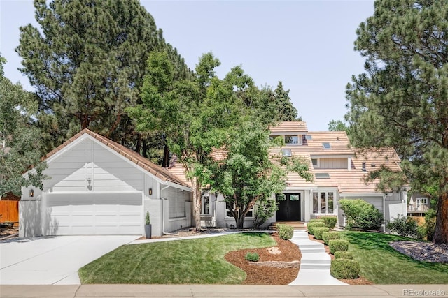 10953 E Crestline Ave, Englewood, CO 80111 - view of front facade with an attached garage, concrete driveway, a front yard, and a tile roof