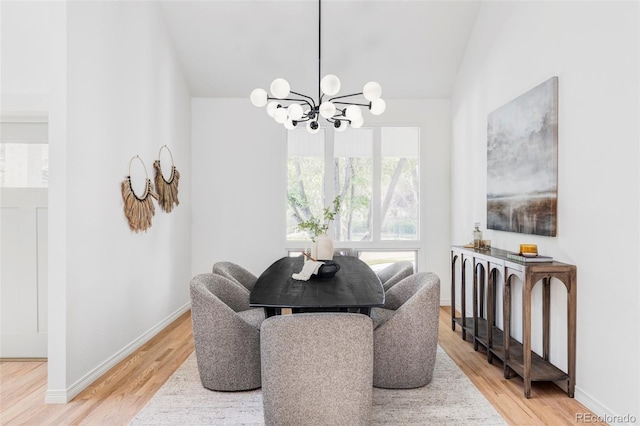 10953 E Crestline Ave, Englewood, CO 80111 - dining space with a chandelier, vaulted ceiling, and light wood finished floors