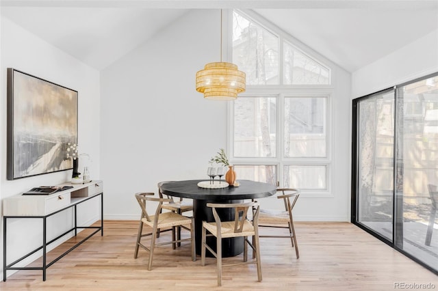 10953 E Crestline Ave, Englewood, CO 80111 - dining space featuring lofted ceiling, light wood-style floors, and a chandelier