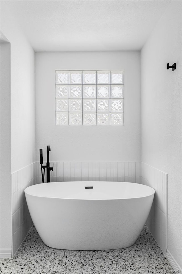 10953 E Crestline Ave, Englewood, CO 80111 - full bathroom with a freestanding tub, healthy amount of natural light, and speckle patterned floor