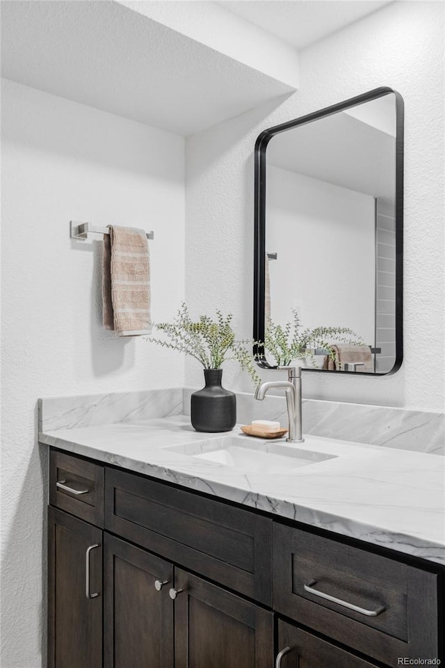 10953 E Crestline Ave, Englewood, CO 80111 - bathroom with vanity and a textured wall