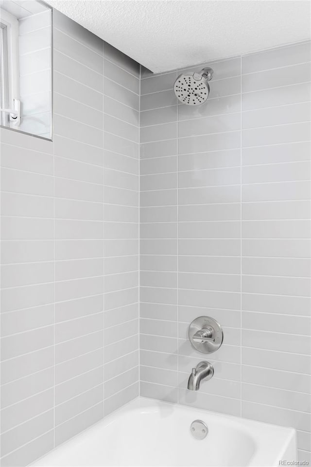 10953 E Crestline Ave, Englewood, CO 80111 - bathroom with a textured ceiling and shower / bathtub combination