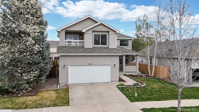 view of front of house featuring roof with shingles, driveway, fence, a garage, and stucco siding