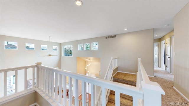 hallway featuring visible vents, recessed lighting, an upstairs landing, and carpet flooring