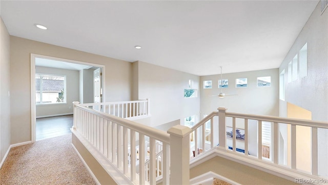 corridor featuring recessed lighting, carpet floors, visible vents, and an upstairs landing