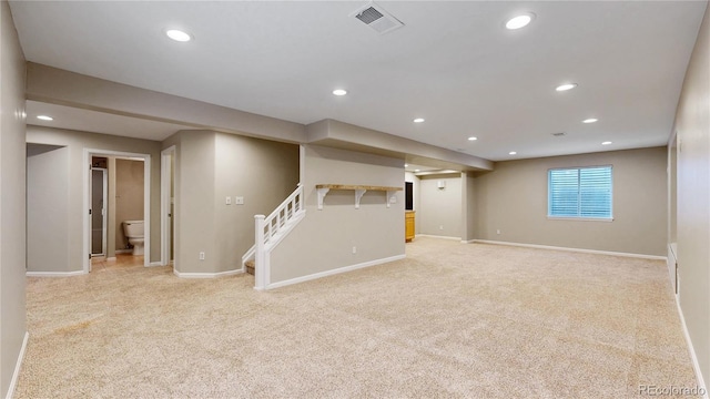 below grade area with recessed lighting, visible vents, stairs, and light carpet