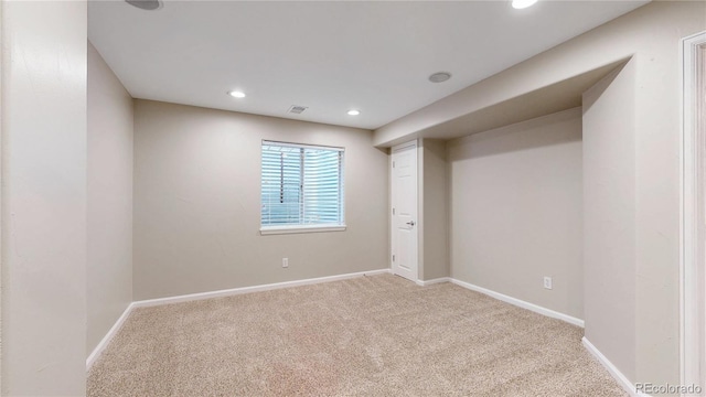 empty room with visible vents, light carpet, baseboards, and recessed lighting