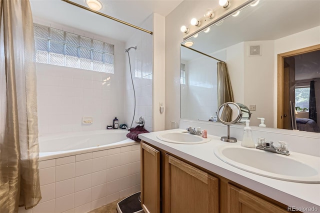 8900 Fox Dr Unit 1, Thornton, CO 80260 - ensuite bathroom featuring tiled shower / bath combo and double vanity