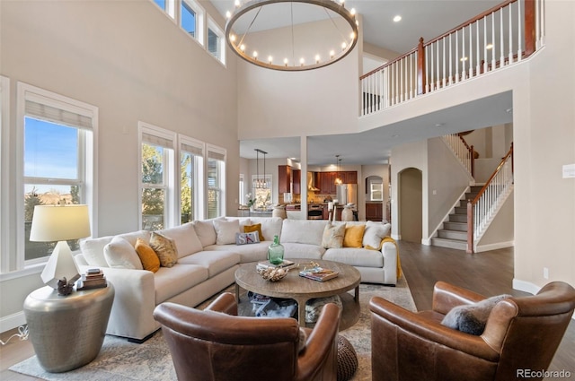 living room featuring an inviting chandelier and light wood-type flooring