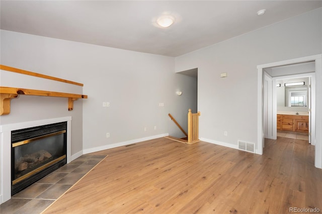 unfurnished living room featuring wood-type flooring