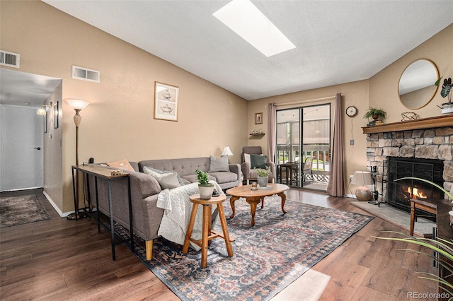 8600 E Alameda Ave Unit 21-208, Denver, CO 80247 - living room with lofted ceiling, wood finished floors, a fireplace, and a skylight