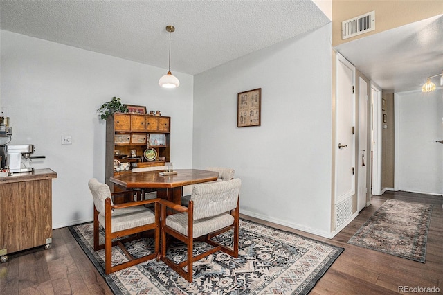 8600 E Alameda Ave Unit 21-208, Denver, CO 80247 - dining area featuring dark wood-type flooring and a textured ceiling