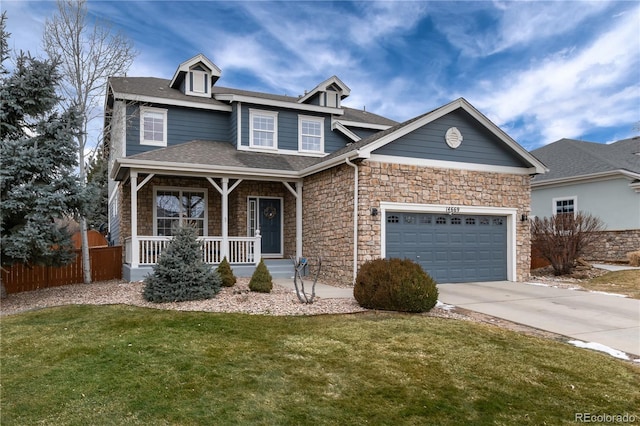 view of front of house featuring a garage, concrete driveway, covered porch, fence, and a front lawn