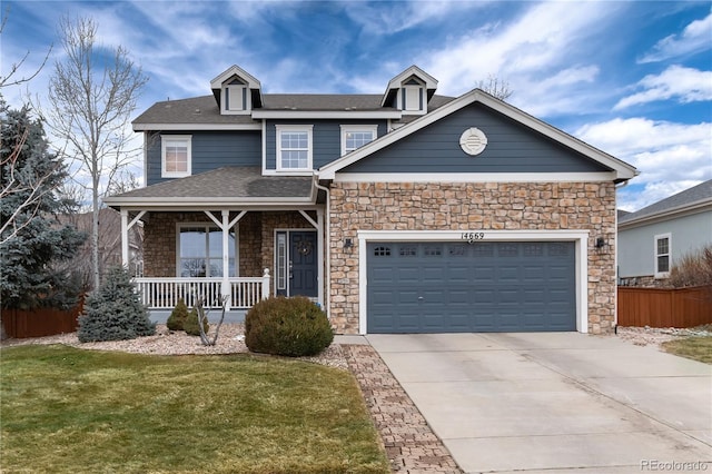 view of front of house with driveway, an attached garage, covered porch, fence, and a front yard