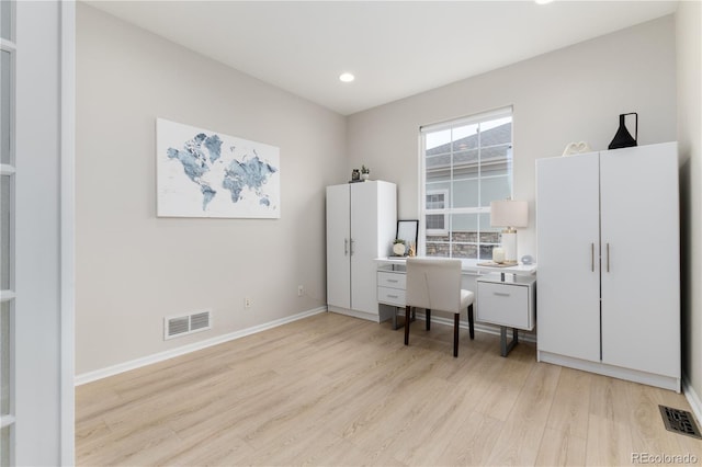 office area with light wood-style floors, recessed lighting, visible vents, and baseboards