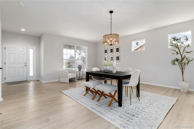 dining area with recessed lighting, a notable chandelier, light wood-style flooring, and baseboards