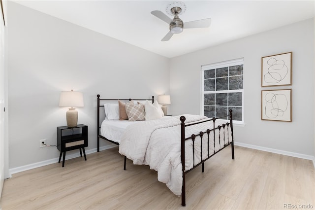 bedroom with light wood-style flooring, baseboards, and a ceiling fan