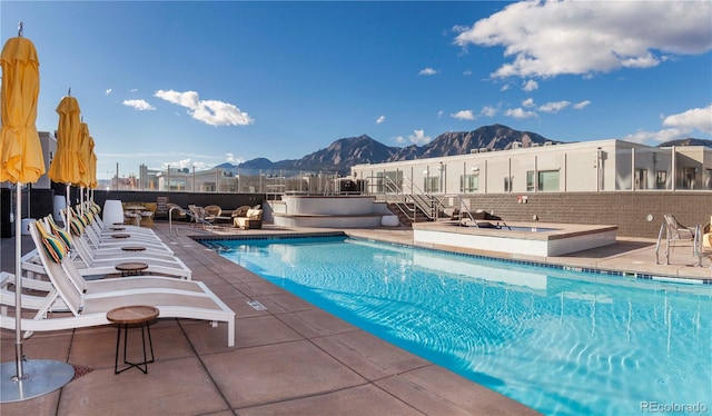 view of pool with a patio area and a mountain view