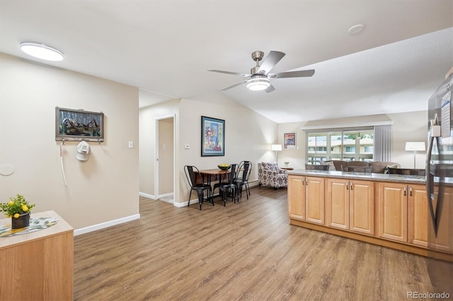 9625 E Center Ave Unit 5D, Denver, CO 80247 - kitchen featuring light wood-type flooring, lofted ceiling, a ceiling fan, baseboards, and light countertops