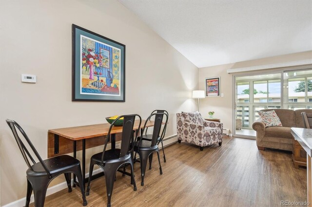 9625 E Center Ave Unit 5D, Denver, CO 80247 - dining space with vaulted ceiling, wood finished floors, and baseboards