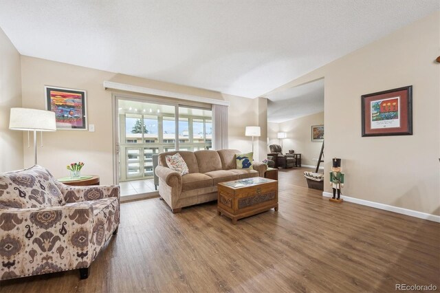 9625 E Center Ave Unit 5D, Denver, CO 80247 - living room with wood finished floors, baseboards, and vaulted ceiling