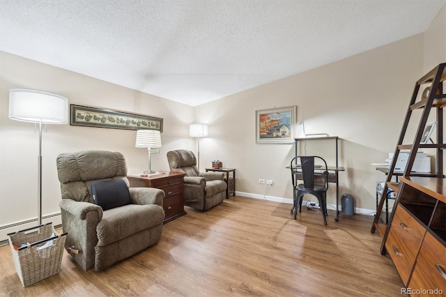 9625 E Center Ave Unit 5D, Denver, CO 80247 - office space with light wood-style floors, a textured ceiling, a baseboard heating unit, and baseboards