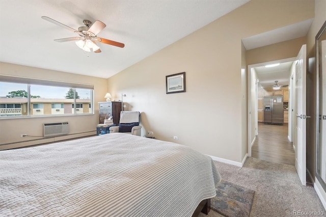9625 E Center Ave Unit 5D, Denver, CO 80247 - bedroom featuring stainless steel fridge, lofted ceiling, carpet flooring, a wall mounted air conditioner, and baseboards