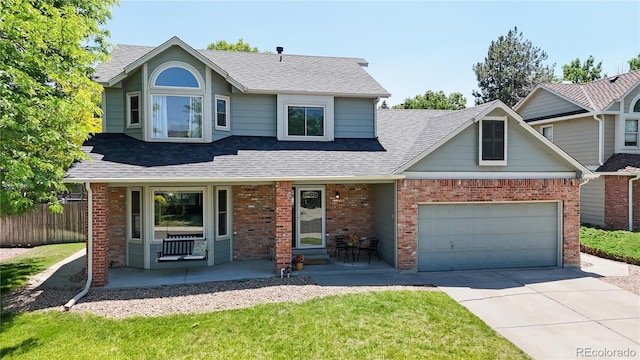 982 E 130th Cir, Thornton, CO 80241 - view of front of house featuring concrete driveway, a porch, brick siding, and roof with shingles