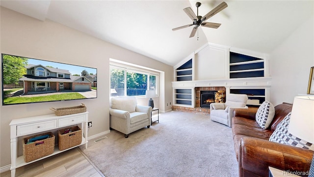 982 E 130th Cir, Thornton, CO 80241 - living area featuring built in features, ceiling fan, a brick fireplace, vaulted ceiling, and wood finished floors