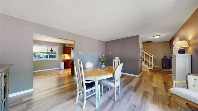 982 E 130th Cir, Thornton, CO 80241 - dining area with stairs and light wood-style floors