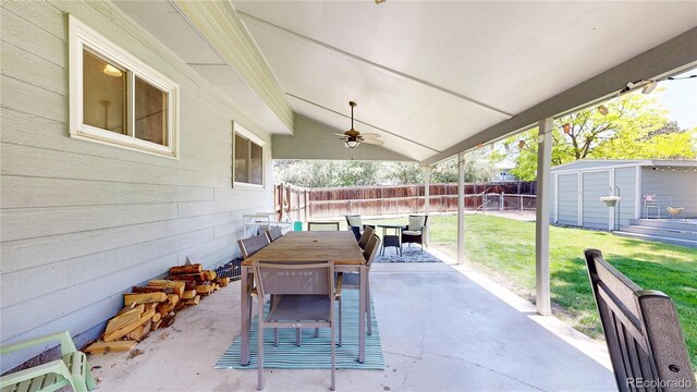 982 E 130th Cir, Thornton, CO 80241 - fenced backyard with a patio area, ceiling fan, outdoor dining space, and a storage shed