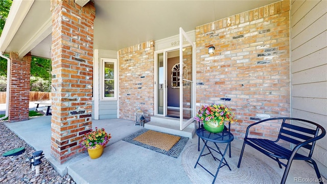 982 E 130th Cir, Thornton, CO 80241 - entrance to property featuring covered porch and brick siding