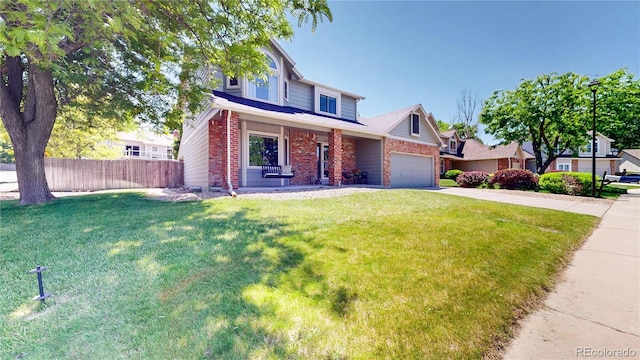 982 E 130th Cir, Thornton, CO 80241 - view of front of house featuring brick siding, driveway, and a garage