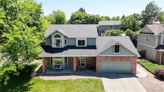 982 E 130th Cir, Thornton, CO 80241 - traditional-style home featuring a porch, concrete driveway, brick siding, and a shingled roof