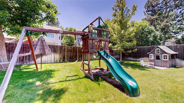 982 E 130th Cir, Thornton, CO 80241 - view of playground featuring a fenced backyard and an outbuilding