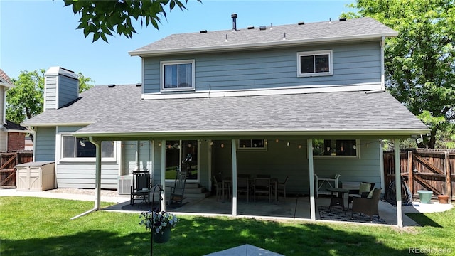 982 E 130th Cir, Thornton, CO 80241 - rear view of house featuring a patio area, roof with shingles, a chimney, and a gate