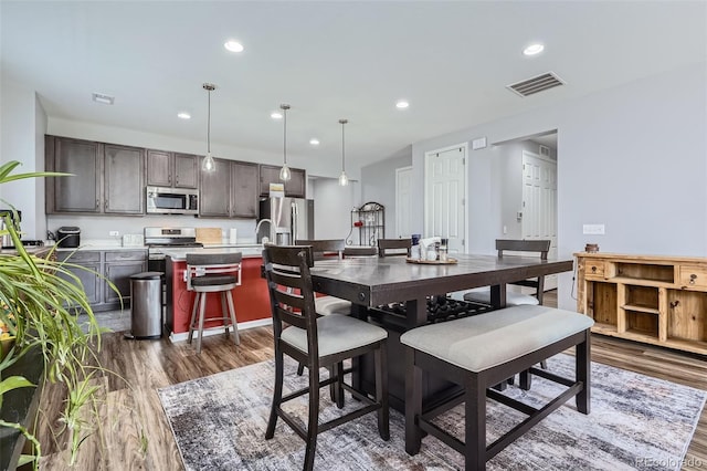 9679 Waco St, Commerce City, CO 80022 - dining space with dark wood finished floors and recessed lighting