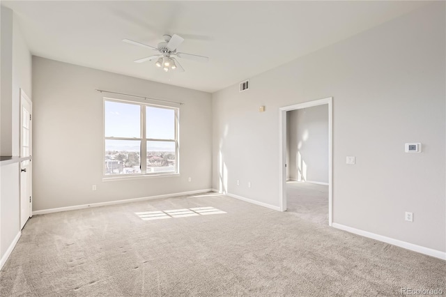 carpeted spare room featuring ceiling fan