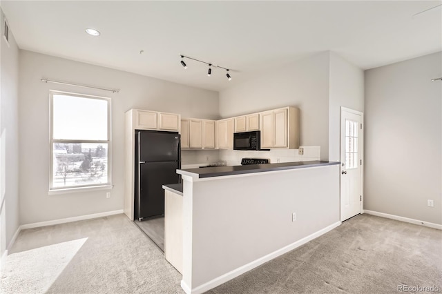 kitchen featuring light carpet, kitchen peninsula, and black appliances