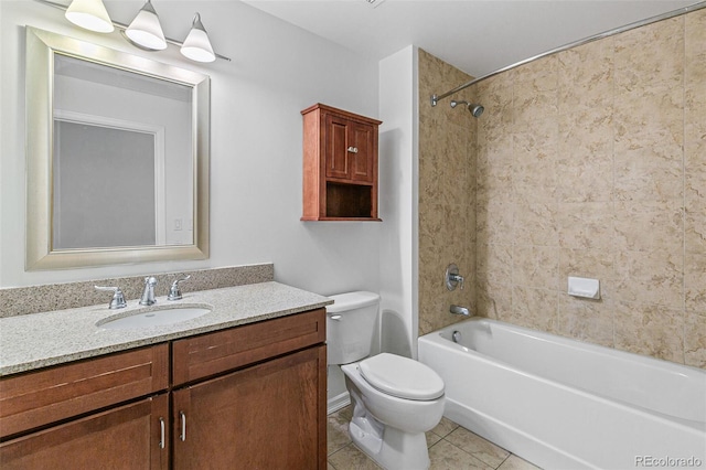 full bathroom featuring tile patterned flooring, tiled shower / bath, vanity, and toilet