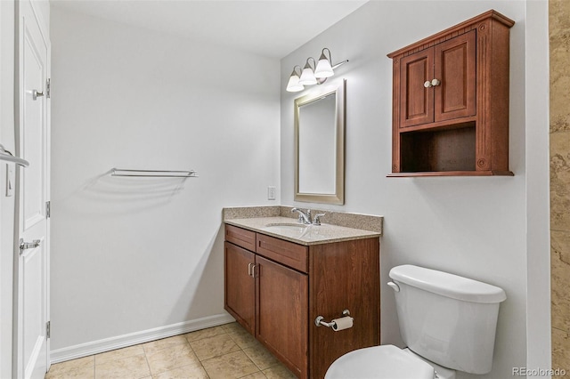 bathroom with vanity, tile patterned floors, and toilet