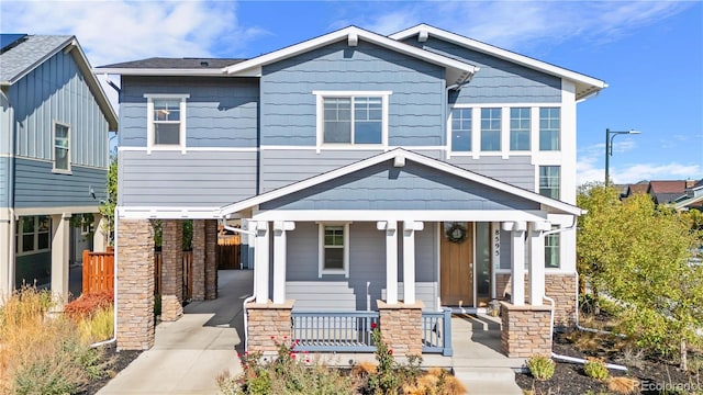 craftsman-style home with covered porch and a carport