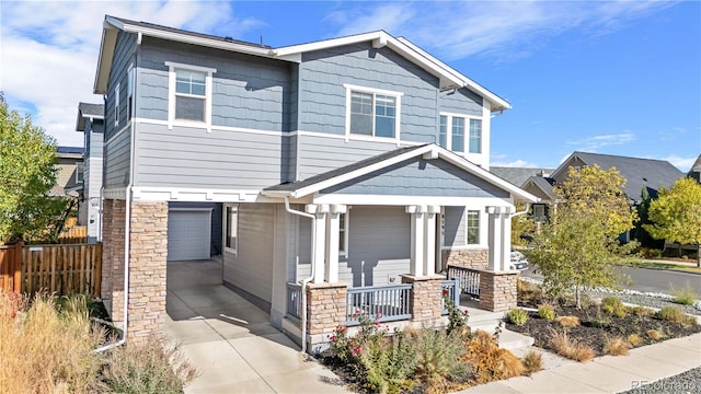 craftsman-style home featuring covered porch and a garage