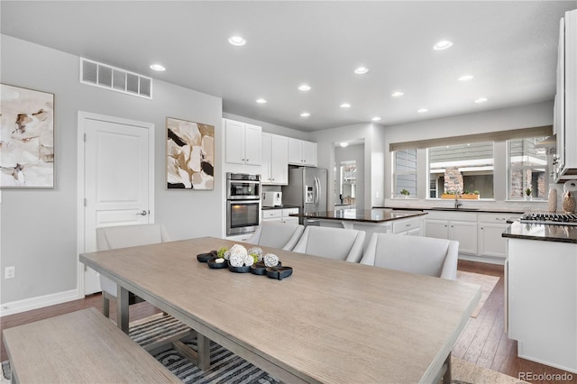 dining area featuring hardwood / wood-style floors and sink