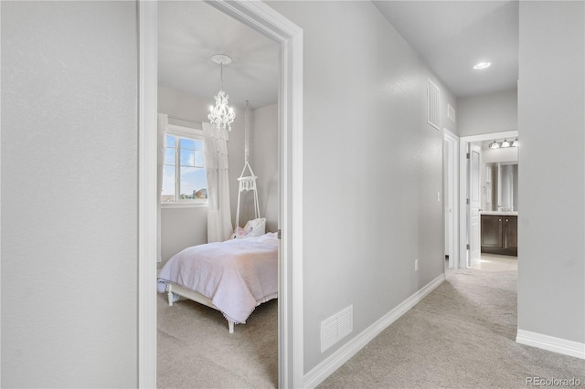 hall featuring a chandelier and light colored carpet