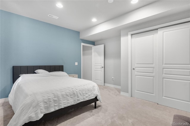 bedroom featuring a closet and light colored carpet