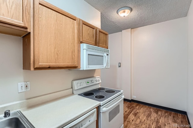 2225 Buchtel Blvd Unit 105, Denver, CO 80210 - kitchen featuring white appliances, light countertops, wood finished floors, and a textured ceiling